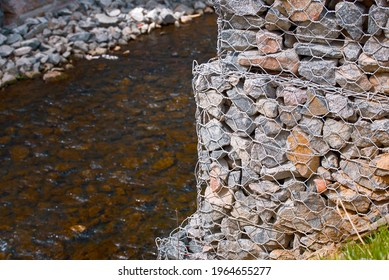 Gabion And Rock Armour - Coast And Waterways Protection. Bridge Support Constructed Using Steel Wire Mesh Basket. Stone Wall, Gabion Revetment - Protection From Backshore Erosion