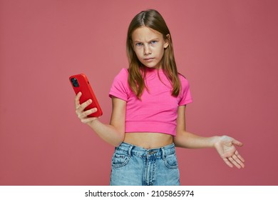 Gadget Addiction. Angry Child Annoyed By Broken Or Discharged Mobile Phone, Bad News, Problem With Mobile Device App