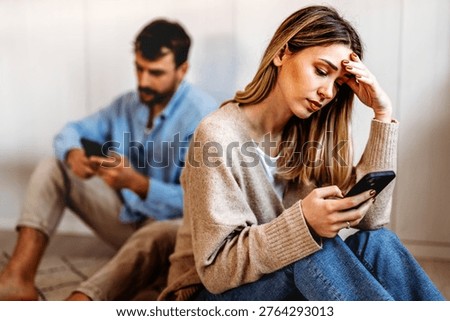 Gadget addiction and relationship problems. Couple with smartphones ignoring each other