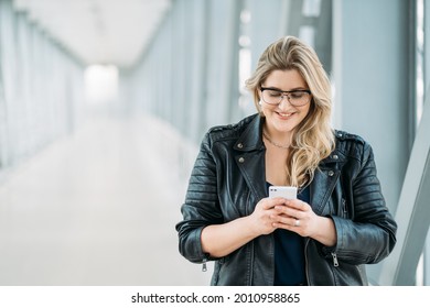 Gadget People. Mobile Communication. Social Media. Body Positive. Happy Smiling Overweight Chubby Obese Woman Using Phone For Online Chat On Light Blur Empty Space Background.