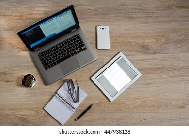 Gadgets and devices on the table : computer, pc, tablet, ipad, glasses, clocks, pen, phone, mobile, smartphone