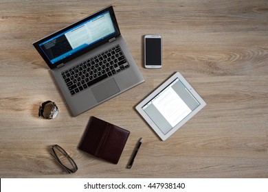 Gadgets and devices on the table : computer, pc, tablet, ipad, glasses, clocks, pen, phone, mobile, smartphone