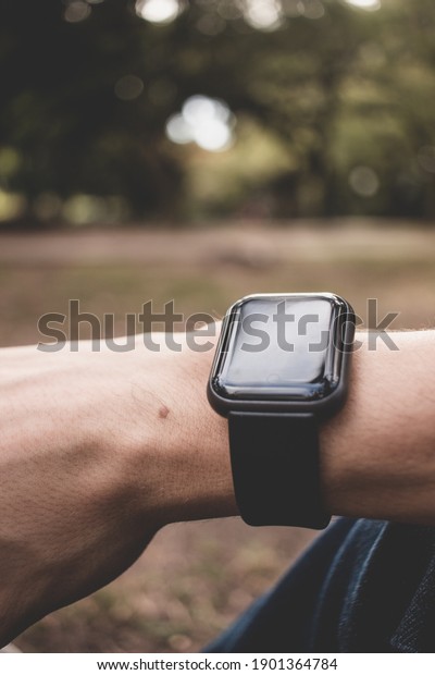 Gadgets for sport. Close Up of smartwatch, free\
space, autumn on park