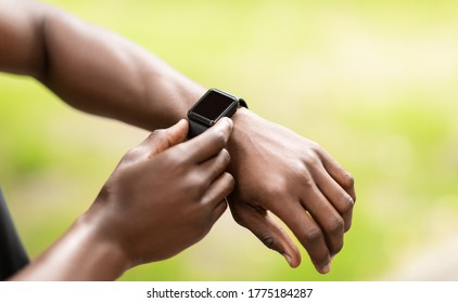 Gadgets for sport. Closeup of smartwatch on african guy sportsman wrist, free space - Powered by Shutterstock