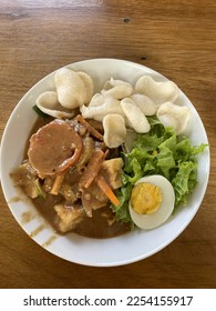 gado-gado or an Indonesian salad of slightly boiled, blanched or steamed vegetables and hard-boiled eggs, fried tofu and tempeh, served with a peanut sauce dressing as topping. - Shutterstock ID 2254155917
