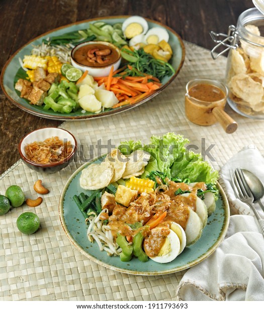 Gado-gado\
Jakarta, containing boiled vegetables and potatoes, boiled eggs,\
fried tofu tempeh, lontong and melinjo chips, served with\
peanut-cashew sauce. Indonesian salad.\
