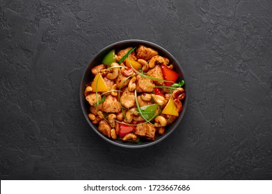 Gai Pad Med Mamuang Or Thai Cashew Chicken In Black Bowl On Dark Slate Backdrop. Kai Med Ma Muang Is Thai Cuisine Dish With Chicken Meat, Capsicum, Onion, Scallions, Chilli. Thai Food. Copy Space