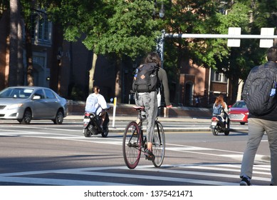 Gainesville, FL United States- 04/15/2019: Students On Scooters And Bikes Make Their Way Towards The Campus Of UF.