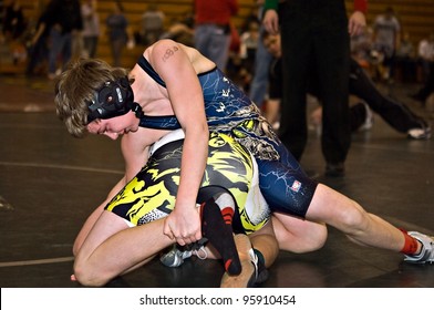 GAINESVILLE, GA, USA - FEB 11: Andy Leggett, The Winner, Holds An Unidentified Opponent In The 11-14 Division Of A Wrestling Tournament, February, 11, 2012, North Hall High School In Gainesville, GA.