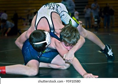 GAINESVILLE, GA, USA - FEB 11: Andy Leggett, Winner, Held By An Unidentified Opponent In The 11-14 Division Of A Wrestling Tournament, February, 11, 2012, North Hall High School Gainesville, GA.