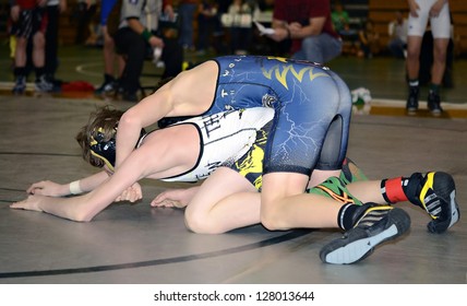 GAINESVILLE, GA, USA - FEB 9: Andy Leggett Holds An Unidentified Opponent In The 11-14 Division Of A Wrestling Tournament, February, 9, 2013, North Hall High School In Gainesville, GA.