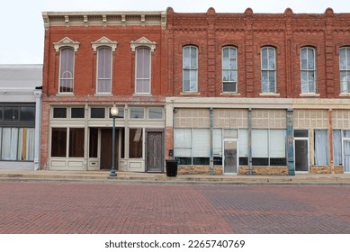 Gainesville, Texas United States - February 10 2023: historic storefronts on a cobblestone street 