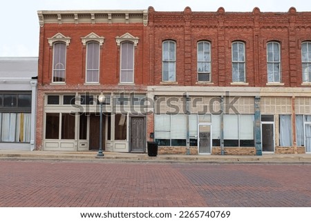 Gainesville, Texas United States - February 10 2023: historic storefronts on a cobblestone street 