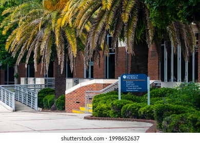 Gainesville, USA - April 27, 2018: University Of Florida Sign On UF Campus With Building For Bookstore, Food Court, Id Card Services And Welcome Center