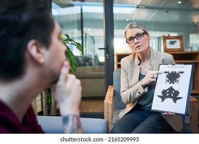 Gaining access into the subconscious mind. Shot of a mature psychologist conducting an inkblot test with her patient during a therapeutic session.