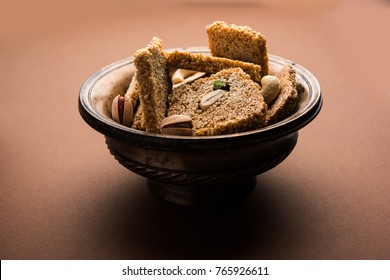 Gajak or til papdi or patti is a dry sweet cake - made of sesame seeds, ground nuts and jaggery, consumed in indian winter especially during Makar Sankranti festival on 14th january