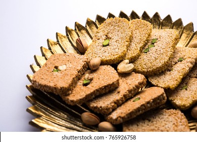 Gajak or til papdi or patti is a dry sweet cake - made of sesame seeds, ground nuts and jaggery, consumed in indian winter especially during Makar Sankranti festival on 14th january