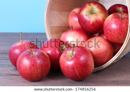 gala apple falling out of bucket on table