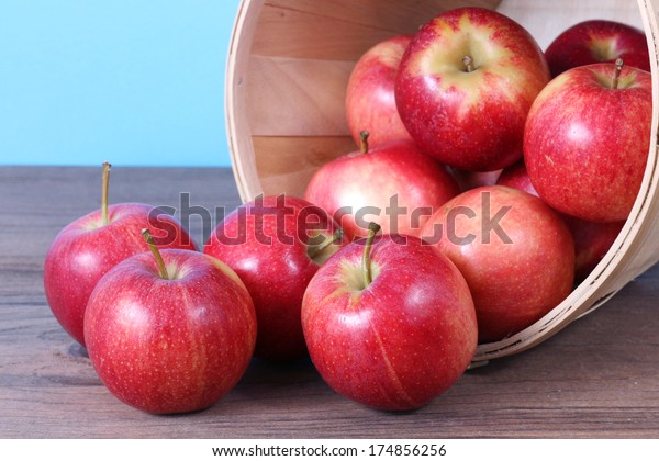 gala apple falling\
out of bucket on table