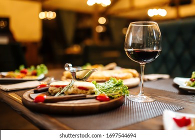 Gala dinner with a glass of red wine, laid table, side view, horizontal