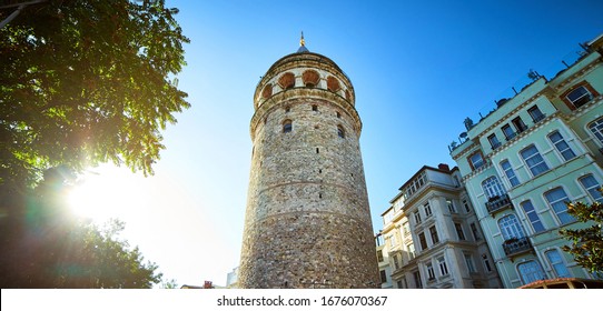 Galata Kulesi Tower and street in the old city of Istanbul, Turkey. Ancient Turkish famous landmark in Beyoglu district, European side. Architecture of the former Constantinople.