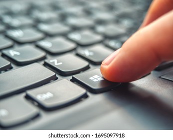 Galati, Romania - April 06, 2020: Laptop User Pressing Windows Key On Microsoft Windows Keyboard