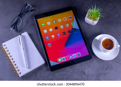 Galati, Romania, March 31, 2021: - Apple Release New IPad 8th Generation With The Powerful A12 Bionic Chip. IPad 8th Generation With Notebook, Coffee Cup, Glasses On Desk.