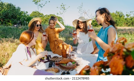 Galentines day. Slumber party. Summer Picnic Party Ideas, Outdoor Gathering with friends. Young women girl friends drinking wine, laughing, having fun together at picnic. - Shutterstock ID 2112478985