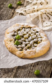 Galette With Fresh Berries. Gooseberry Rustic Tart On Rough Wooden Background. Selective Focus  