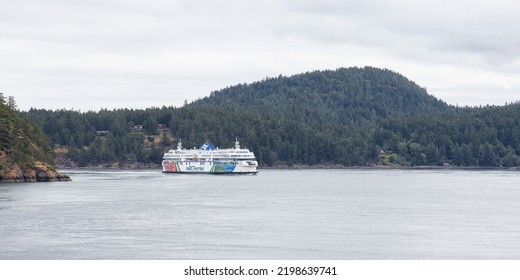 Galiano Island, British Columbia, Canada - June 22, 2022: BC Ferries Boat In Pacific Ocean During Cloudy Summer Day.