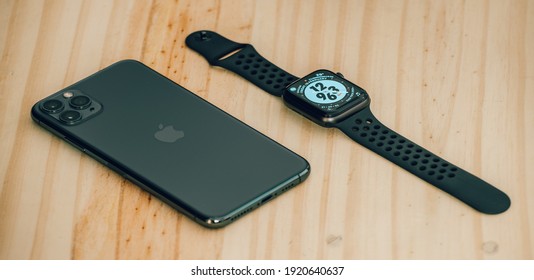 Galle, Sri Lanka - 02 19 2021: Apple IPhone 11 Pro Max And Apple Watch Series 6 Lay Flat On A Wooden Table, Luxury And Lifestyle Concept.
