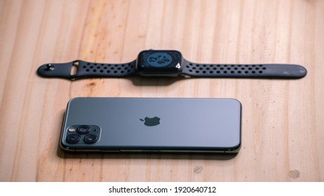 Galle, Sri Lanka - 02 19 2021: Apple IPhone 11 Pro Max And Apple Watch Series 6 Lay Flat On A Wooden Table, Luxury And Lifestyle Concept.
