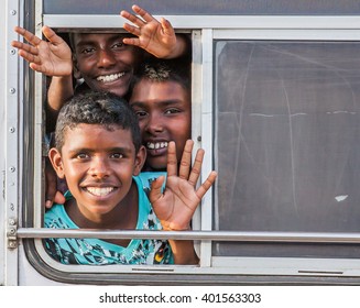 GALLE, SRI LANKA - CIRCA AUGUST 2015: Kids Are Waving Through The Bus Window