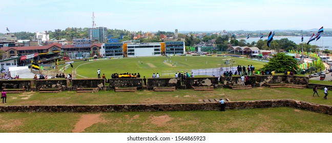 Galle / Sri Lanka - March, 15, 2019 – Fans Watching A Cricket Match Happening At Galle International Stadium. They Are Sitting In The Walls Of The Old Walled Town Of Galle, A Former Colonial City That