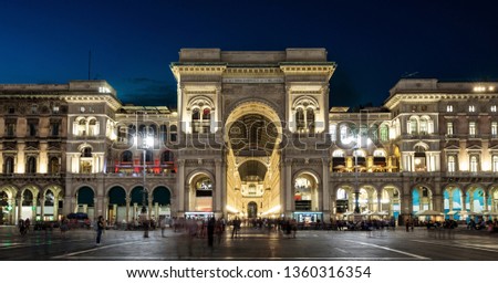 Galleria Vittorio Emanuele II at night, Milan, Italy. It is a famous landmark of Milan. Panorama of the Piazza del Duomo in the Milan center at dusk. Beautiful old architecture of Milan in evening.