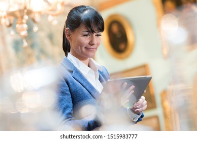 Gallery Curator Looking At Tablet