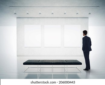 Gallery Room And Man Looking At Empty Frames
