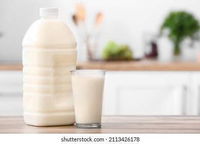 Gallon Bottle And Glass Of Milk On Table In Kitchen