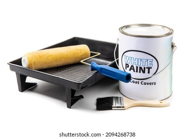 A Gallon Can Of Paint With A Fake, Generic, White Paint Label, With A Yellow Roller And Brush And A Black Plastic Paint Tray Isolated On White