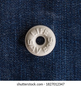 Galloway, NJ - Oct 4, 2020: One Single White Mint Life Saver On A Blue Denim Background In Square Format