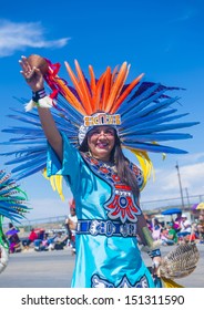 GALLUP , NEW MEXICO - AUGUST 10 :Aztec dancer with traditional costume participates at the 92 annual Inter-tribal ceremonial parade on August 10 , 2013 in Gallup New-Mexico