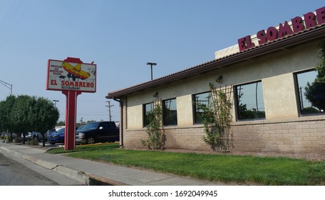 Gallup, New Mexico- August 2018: Side view of El Sombrero Restaurant with a roadside billboard in Gallup, New Mexico.