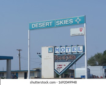 Gallup, New Mexico- August 2018: Roadside billboard and sign infront of Super Desert Skies, one of the motels in Gallup, New Mexico.