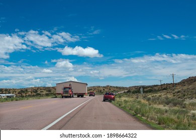 Gallup, New Mexico - July 15, 2014: A trailer truck transporting a mobile home on the road near the city of Gallup, New Mexico, USA