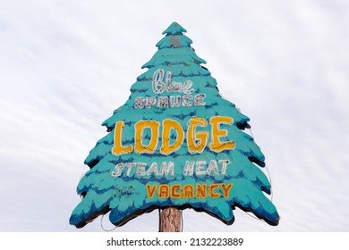 Gallup, New Mexico, USA, February 10, 2019 - Exterior low angle daytime view of historic Blue Spruce Lodge sign in the shape of a tree, located along Route 66