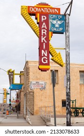 Gallup, New Mexico, USA, February 10, 2019 - Exterior daytime view of vintage downtown parking and Rex Museum signs on Route 66