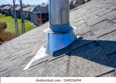 Galvanized metal chimney exhaust with boot on  asphalt roof
