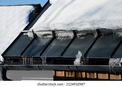 Galvanized Metal Roof In The Mountains With A Bar Against The Rapid Sliding Of Snow. If Snow And Ice Quickly Fall On People Under The Roof, They Will Be Injured Or Dead. Slows Down The Avalanche