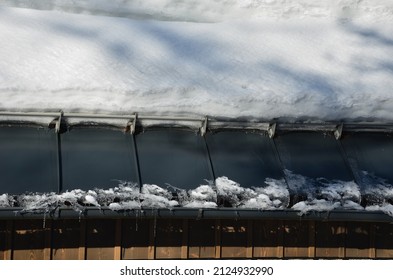 Galvanized Metal Roof In The Mountains With A Bar Against The Rapid Sliding Of Snow. If Snow And Ice Quickly Fall On People Under The Roof, They Will Be Injured Or Dead. Slows Down The Avalanche