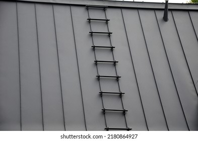 Galvanized Metal Roof In The Mountains With A Bar Against The Rapid Sliding Of Snow. If Snow And Ice Quickly Fall On People Under The Roof, They Will Be Injured Or Dead. Slows Down The Avalanche